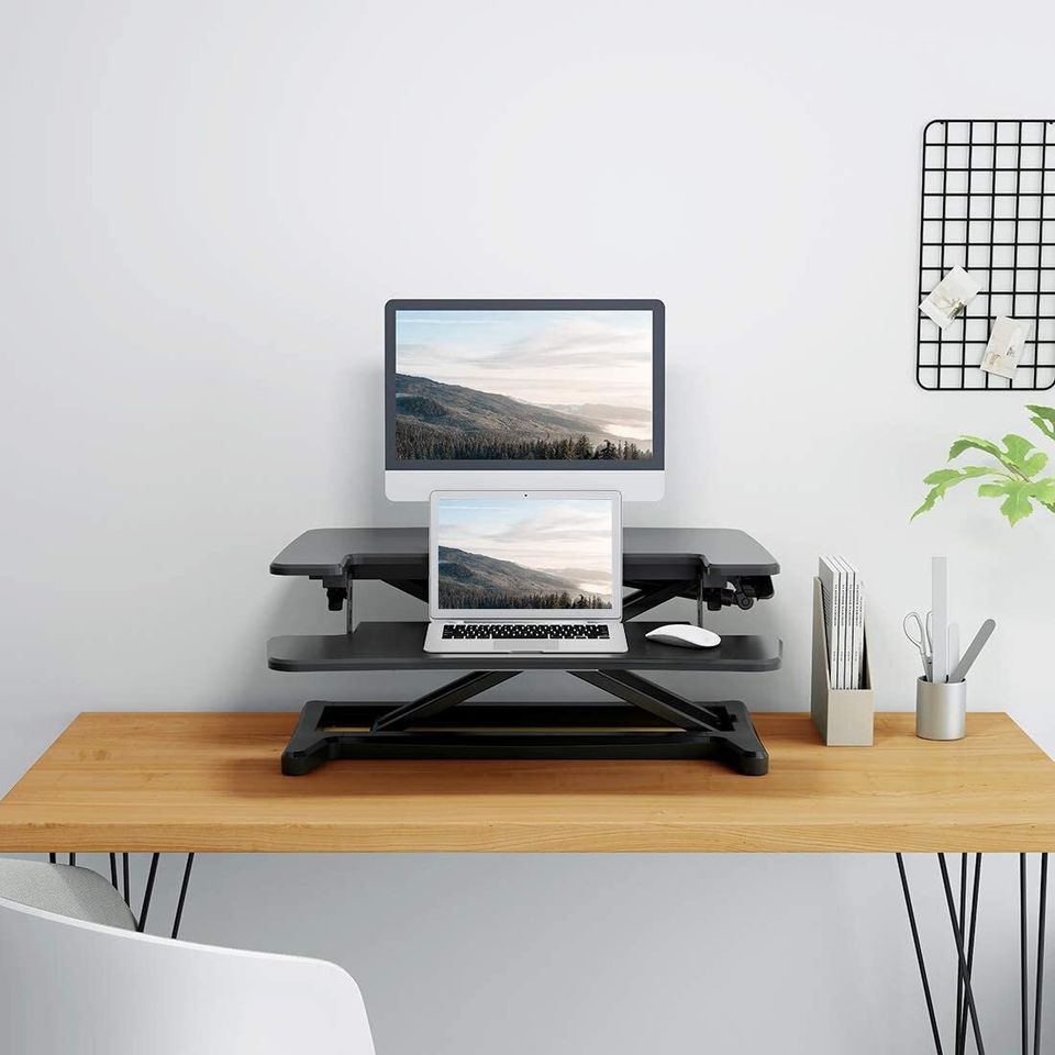 A tabletop standing desk with adjustable heights