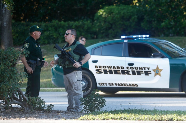 Law enforcement officers block off a street leading to Marjory Stoneman Douglas High School on Feb. 14, 2018, in Parkland, Florida, following a mass shooting at the school.