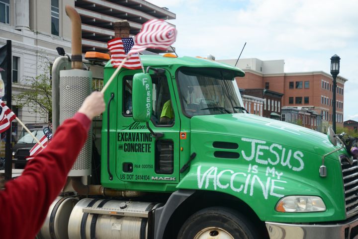 A truck bearing the message "Jesus is my vaccine" blares its siren in support while passing anti-quarantine and pro-Trump protestors took over the steps of the Pennsylvania State Capitol.