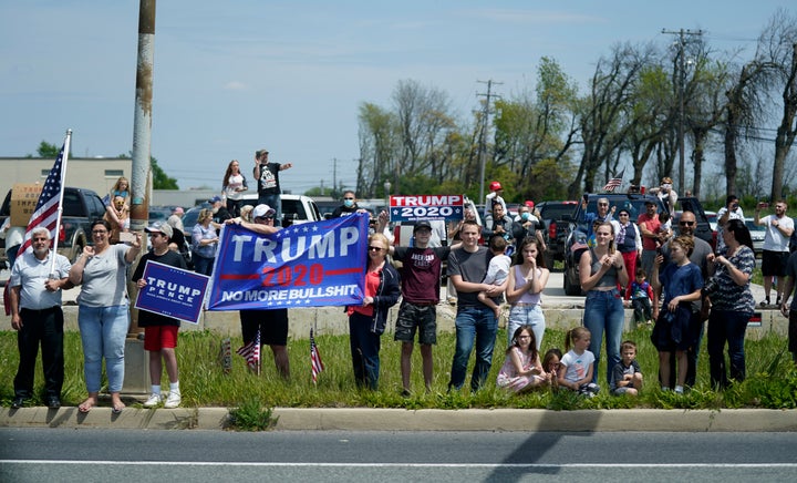 People watch as a motorcade with President Donald Trump drives past on Thursday, May 14, in Allentown, Pennsylvania.