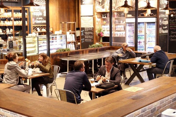 Customers sit at a cafe on the first morning of eased coronavirus disease (COVID-19) restrictions, allowing up to 10 patrons to sit at a time inside establishments previously only opened for take-away, in Sydney, New South Wales, Australia, May 15, 2020. 