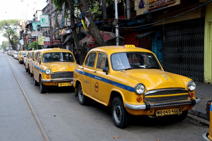 Yellow Ambassador Taxi are parked on a roadside on the first day of the government-imposed nationwide lockdown in Kolkata on March 25, 2020. 