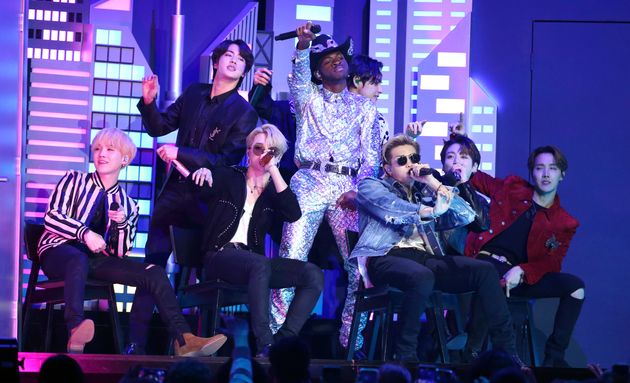 Lil Nas X, background center, and members of BTS perform 