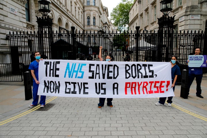 Nurses who work at central London hospitals protest outside Downing Street in on May 13, 2020 calling for improved conditions and pay for nursing staff.