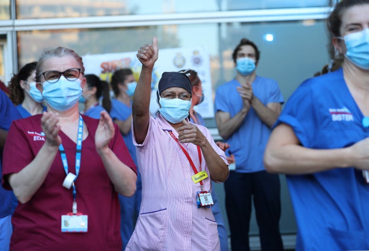 NHS workers outside the Royal London Hospital in Whitechapel, London, to salute local heroes during Thursday's nationwide clap for carers.