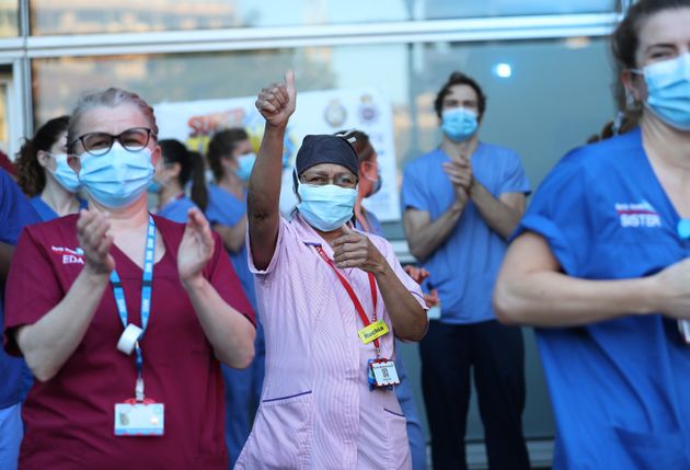 NHS workers outside the Royal London Hospital in Whitechapel, London, to salute local heroes during Thursday's nationwide clap for carers.