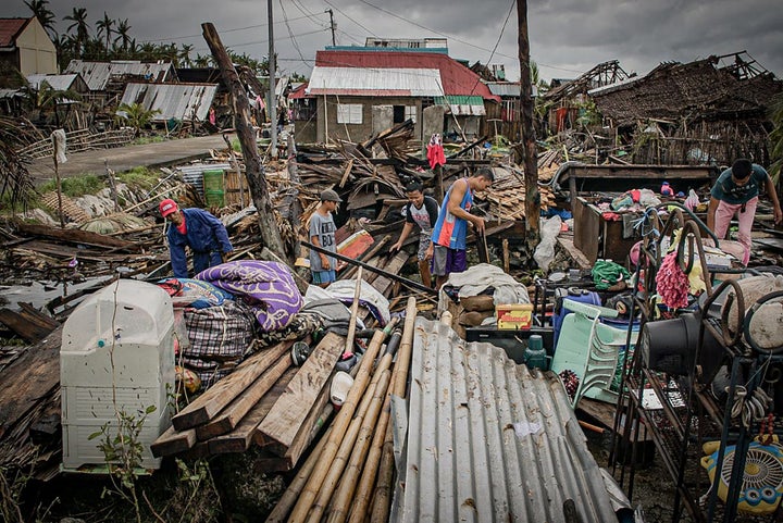 Residents try to salvage belongings amongst their houses destroyed at the height of Typhoon Vongfong in San Policarpo town, Eastern Samar province on May 15, 2020, a day after the typhoon hit the town. 