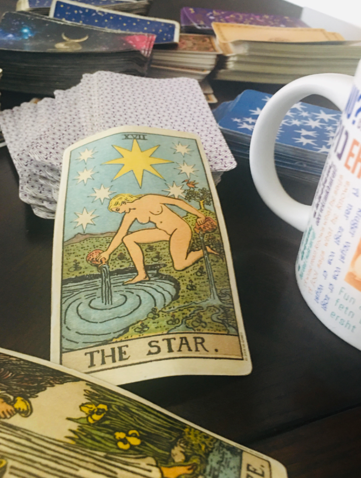 The Star card is displayed among a collection of the author's tarot decks.