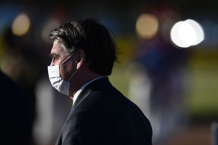 Brazilian President Jair Bolsonaro wears a face mask as he arrives at the flag-raising ceremony before a ministerial meeting at Alvorada Palace in Brasilia, Brazil, on May 12, 2020.