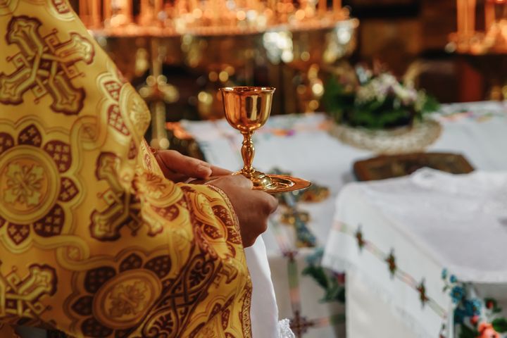 Consecrated bread and wine in chalice on Holy See, during orthodox liturgy on Easter