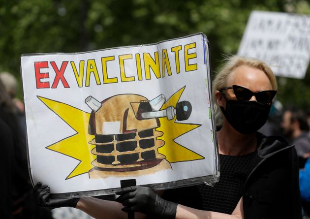 A protestor holds up a banner during a mass gathering protest organised by the group called 'UK Freedom Movement', in Hyde Park.