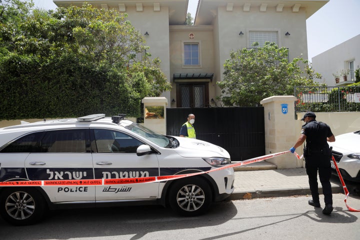 An Israeli policeman cordons off an area near the house of China's ambassador to Israel, Du Wei, in Herzliya, near Tel Aviv,