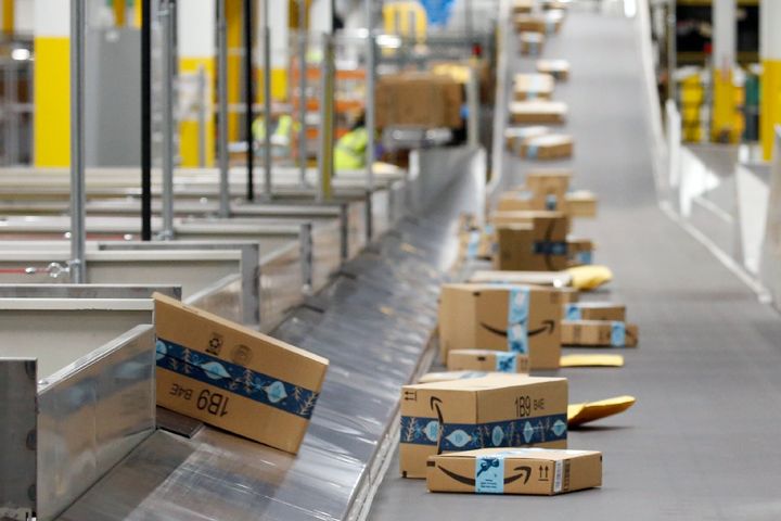In this Dec. 17, 2019, file photo, Amazon packages move along a conveyor at an Amazon warehouse facility in Goodyear, Ariz.