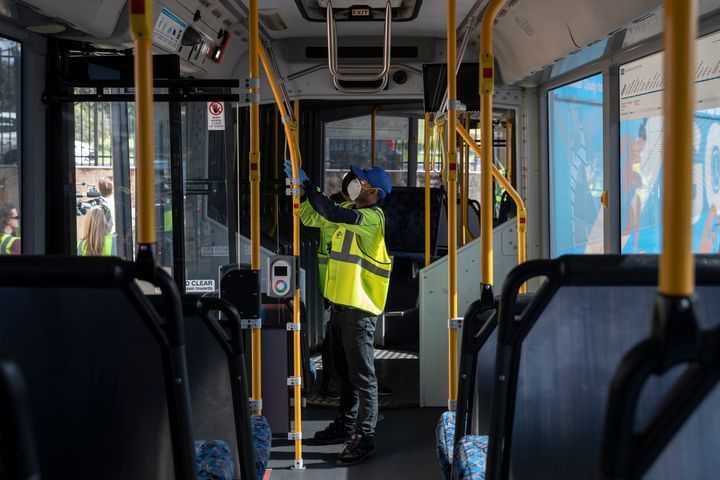 Cleaners are pictured at work while wearing PPE at the Waverley Bus Depot on April 29, 2020 in Sydney, Australia. 