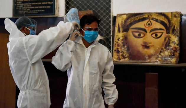 Medical health workers prepare beforethe first special train arrives in Kolkata which departed from Vellore,...