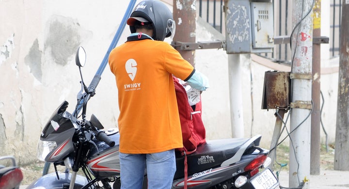 Swiggy delivery agent is seen at work during lockdown, on April 20, 2020 in Noida.