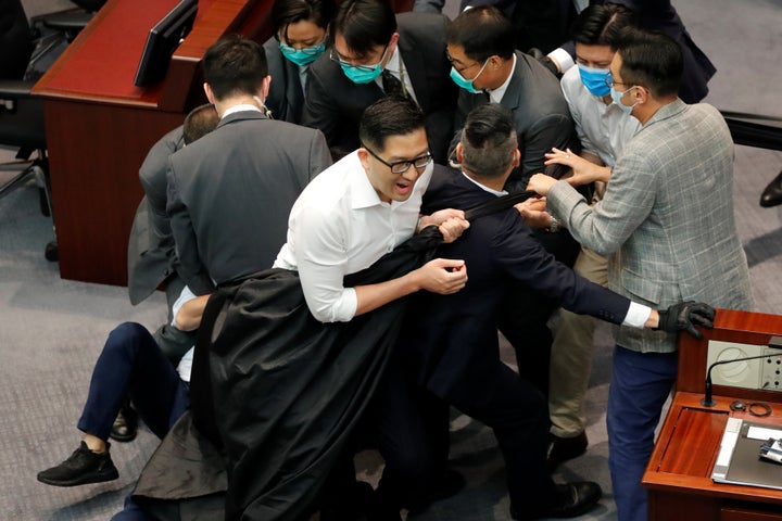 Pan-democratic legislators Lam Cheuk-ting, Jeremy Tam Man-ho and Alvin Yeung scuffle with security during Legislative Counci