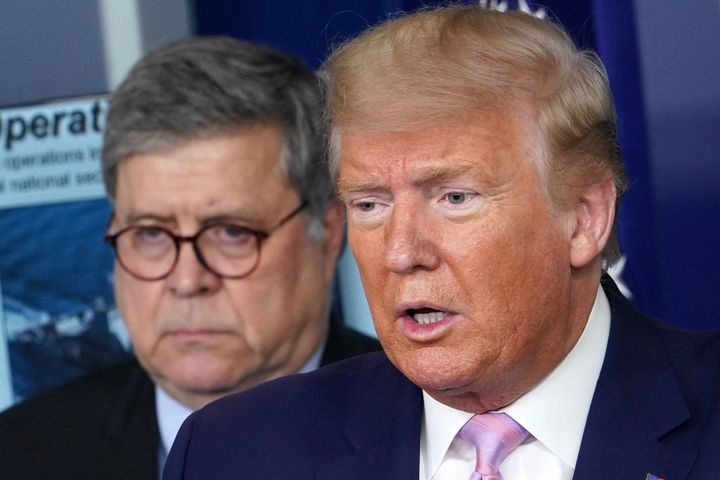President Donald Trump speaks, flanked by Attorney General William Barr (left), during the daily briefing on the novel coronavirus on April 1.
