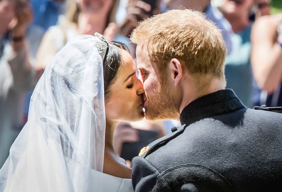 The Duke and Duchess of Sussex kiss as they leave from the West Door of St. George's Chapel after their wedding ceremony.