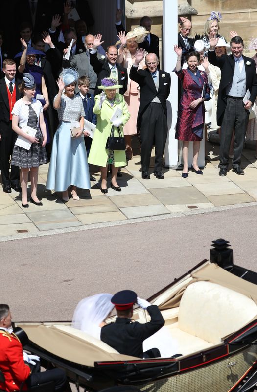 The Duke of Sussex salutes members of the Royal family, including, from left, Lady Louise Windsor, Sophie, Countess of Wessex, James, Viscount Severn, Queen Elizabeth II, Princess Michael of Kent, Prince Edward, Prince Philip, Princess Anne and Vice Adm. Sir Timothy Laurence.