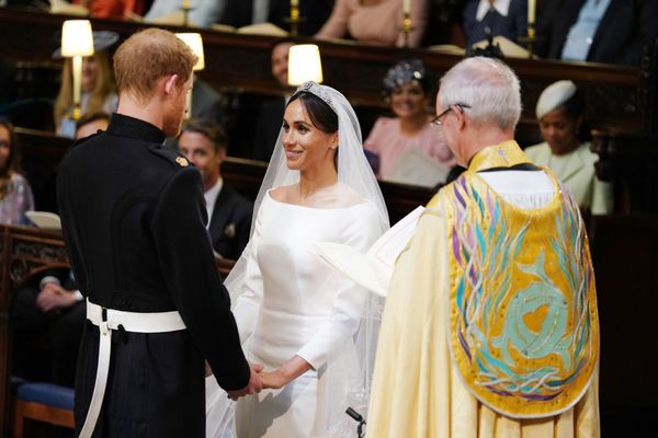 The couple holding hands during their wedding service, conducted by the Archbishop of Canterbury Justin Welby.