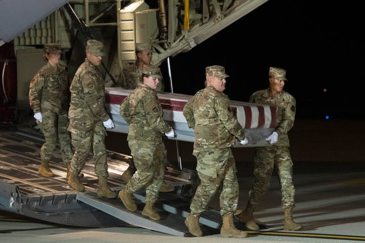 An Air Force carry team moves a transfer case containing the remains of Navy Ensign Joshua Watson on Sunday, Dec. 8, 2019, at Dover Air Force Base, Del. A Saudi gunman killed three people including 23-year-old Watson, a recent graduate of the U.S. Naval Academy from Enterprise, Ala., in a shooting at Naval Air Station Pensacola in Florida. (AP Photo/Cliff Owen)