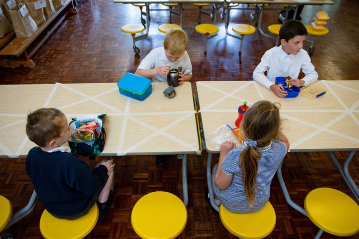 Children of essential workers eat lunch in segregated positions at Kempsey Primary School in Worcester.