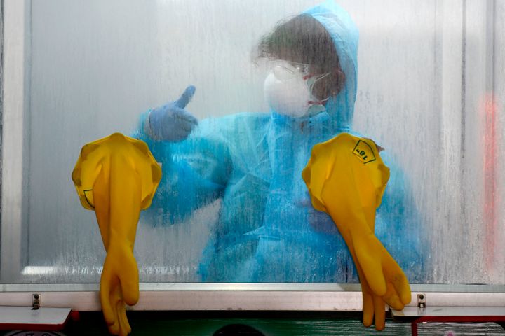 A medical technician gestures at a COVID-19 testing and sample collection centre in Chennai on April 14, 2020.