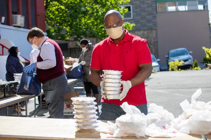 Jamaal Bowman distributes food at a food bank in Yonkers, New York. His presence in the district has helped win him the backing of an influential union.
