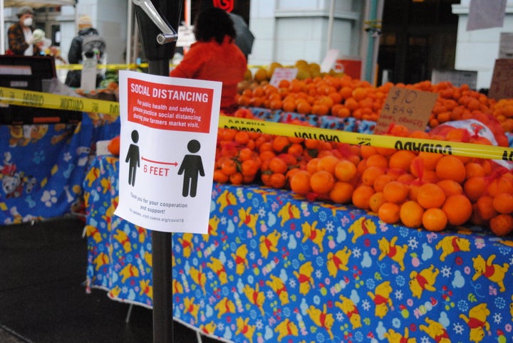 Caution tape prevents shoppers from touching the produce at the Ferry Plaza Farmers Market in San Francisco.