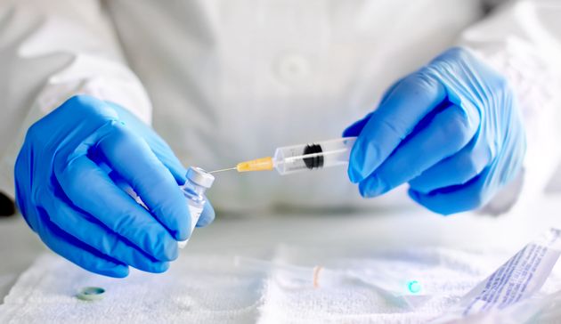 A file image of a doctor filling a syringe with a