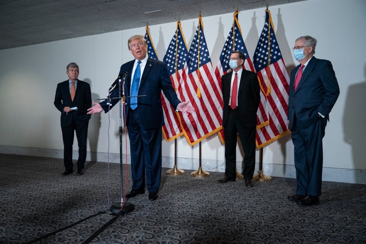 President Trump speaks to the press after a policy meeting with Republican senators Tuesday.