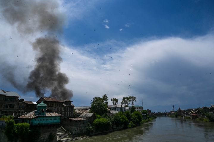 Smoke rises from a house at a site of a gun battle between militants and government forces in Srinagar, Jammu and Kashmir, on May 19, 2020. 
