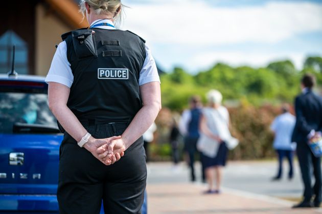 A West Mercia Police officer stands while social distancing at the funeral of Jodon Gait, a healthcare assistant at Worcestershire Royal Hospital who died of Covid-19