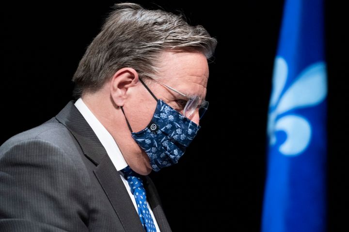 Quebec Premier Francois Legault, wearing a protective mask, walks away following a news conference in Montreal on May 15, 2020. 
