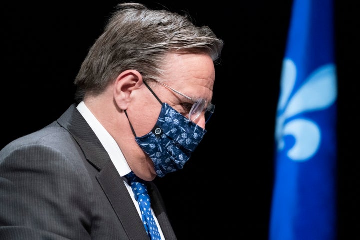 Quebec Premier Francois Legault, wearing a protective mask, walks away following a news conference in Montreal on May 15, 2020.
