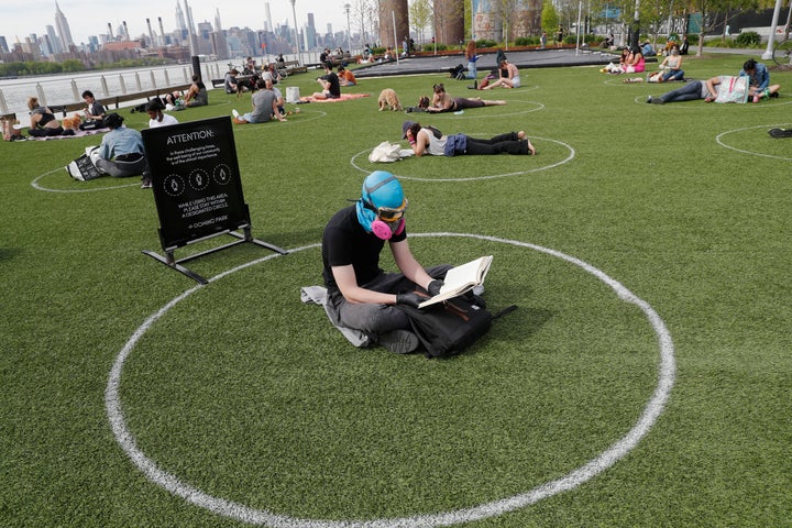 Ridley Goodside wears a rubber diving head covering along with goggles and a special air filtration mask in Domino Park.