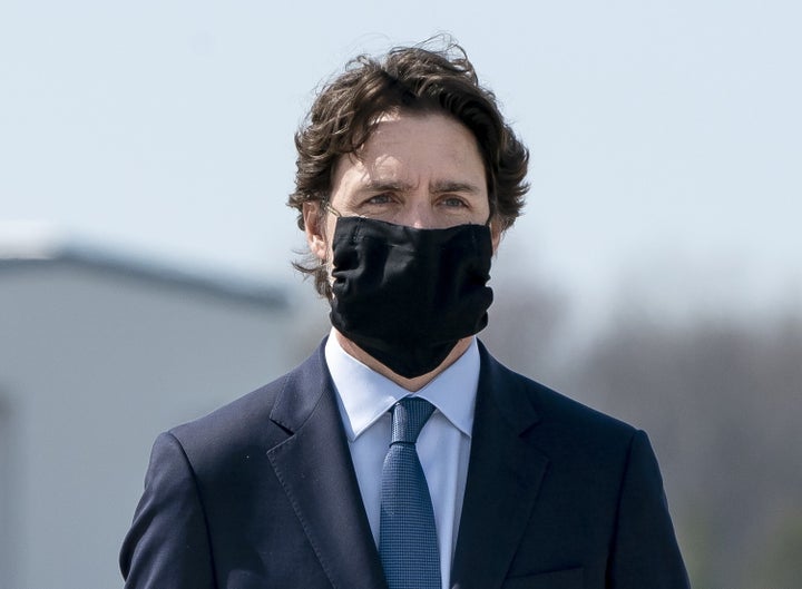 Prime Minister Justin Trudeau wears a mask at a repatriation ceremony on May 6, 2020 at CFB Trenton, Ont. for the six Canadian Armed Forces members killed in a helicopter crash off of Greece.