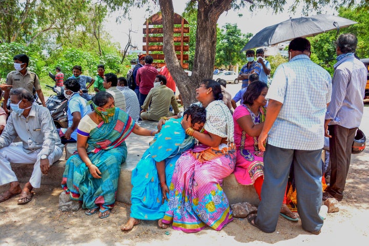 Family members react as they mourn deceased relatives a day after a gas leak incident at LG Polymers plant, at King George Hospital mortuary in Visakhapatnam on May 8, 2020.