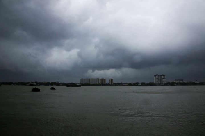 Rain clouds hover over the Hooghly River in Kolkata, India, Wednesday, May 20, 2020. 
