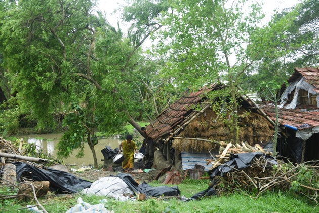 A woman salvages items from her house damaged by cyclone Amphan in Midnapore, West Bengal, on May 21,