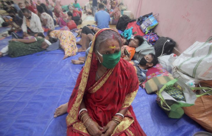 Residents rest in a shelter ahead of the expected landfall of cyclone Amphan in Dhamra area of Bhadrak district in Odisha on May 20, 2020. 