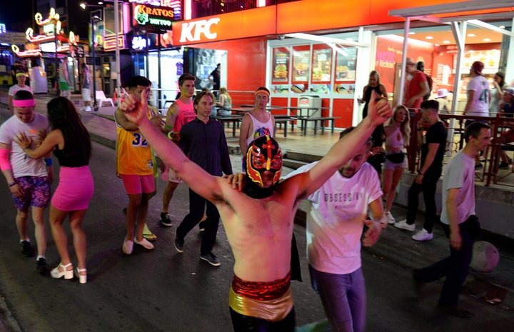 Tourists on the street in Magaluf, in Calvia town, on the Spanish Balearic island of Mallorca