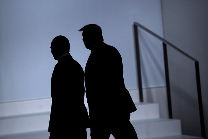 Russia's President Vladimir Putin (L) and US President Donald Trump arrive for a group photo at the G20 Summit in Osaka on Ju