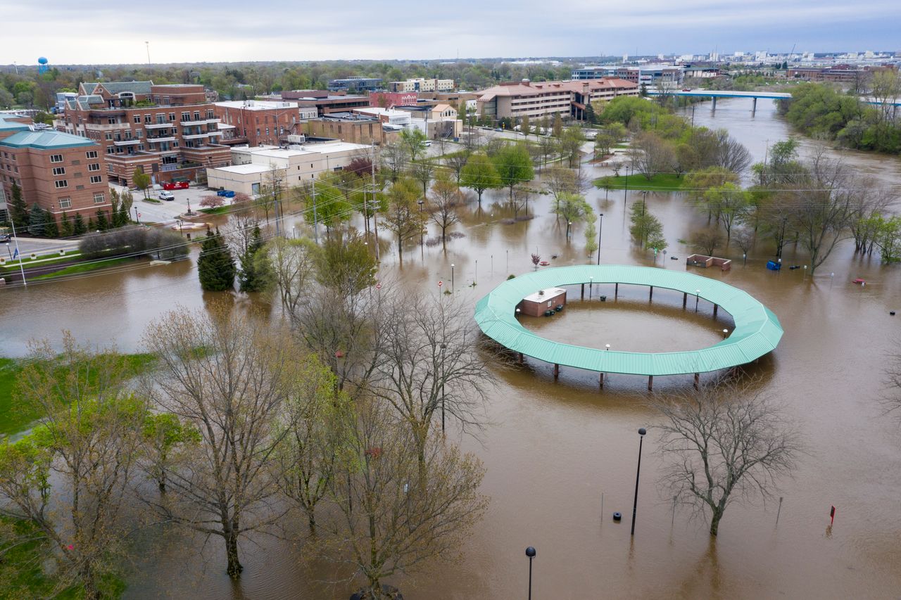Water floods the Midland Area Farmers Market and the bridge along the Tittabawassee River in Midland, Michigan, on May 19, 2020. 