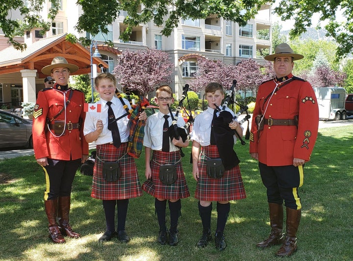 Jesse Buchanan, left, Seamus Grant, centre, and Eli McPhail, right, alternate playing outside the funeral home.