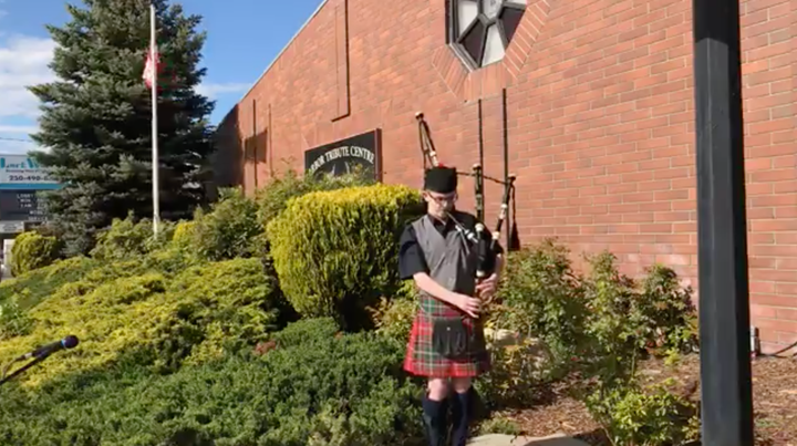 Seamus Grant plays outside Providence Funeral Home in Penticton, B.C. on May 15, 2020. 