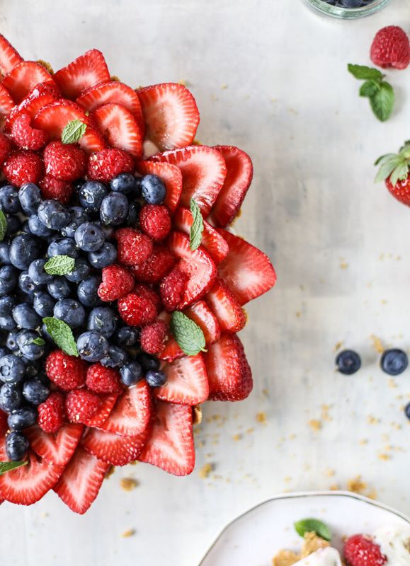 Get the No-Bake Cheesecake Triple Berry Star Tart recipe from How Sweet Eats