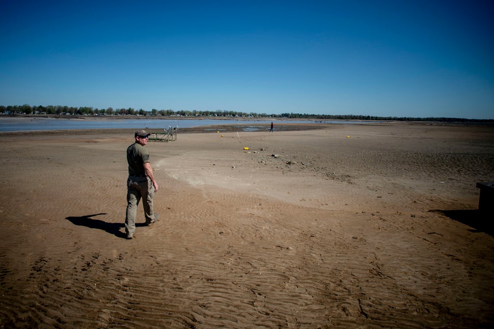 Sanford resident Clint Clark, 44, walks out into what was once the bottom of Wixom Lake after water washed out due to the fai