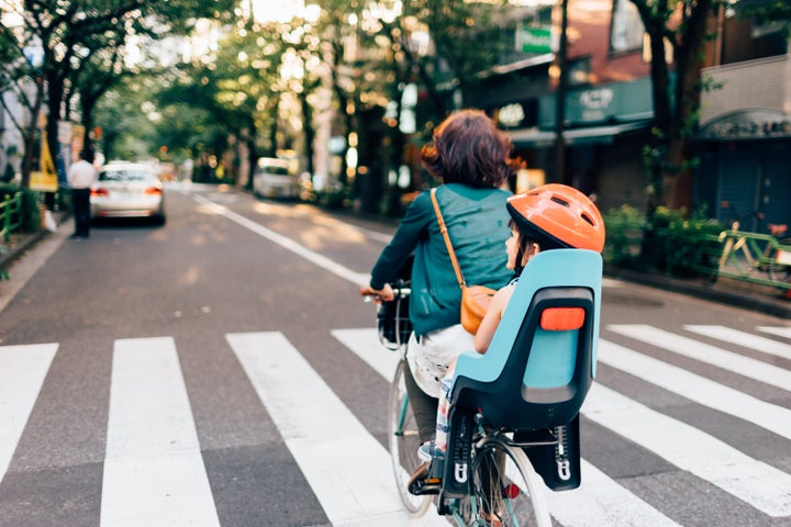 Mother on the way home by bicycle with her child, Tokyo